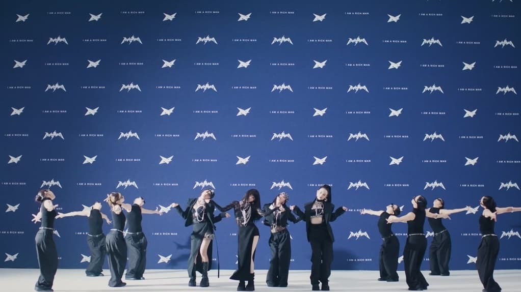 aespa in the 'Rich Man' M/V, with the 'I AM A RICH MAN' concept backdrop — YouTube: SMTOWN